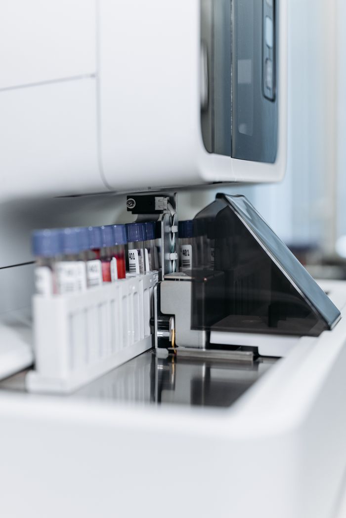 Mastering the First Impression: Your intriguing post title goes here Close-up of an automated laboratory machine handling test tubes for research.